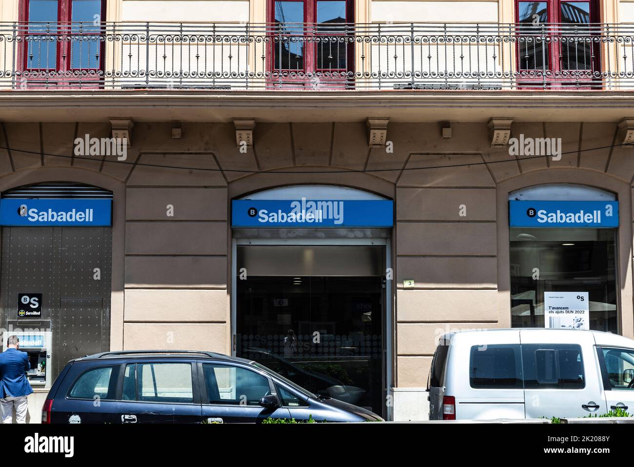 Tortosa, Spain - May 13, 2022: Facade and logo of the Banco Sabadell with people at the ATM in Tortosa, Catalonia, Spain Stock Photo