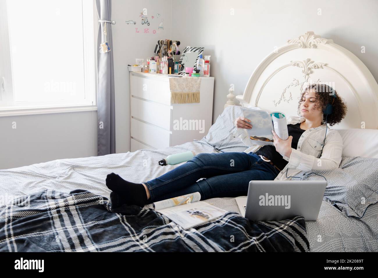 Serious girl lying on bed hi-res stock photography and images - Alamy
