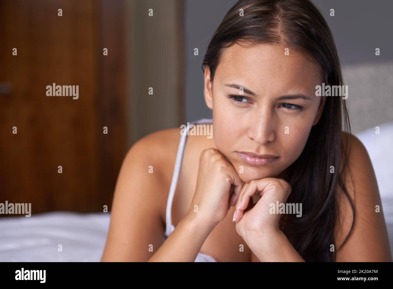 Enjoying the peace of the morning. a young woman lying on her bed