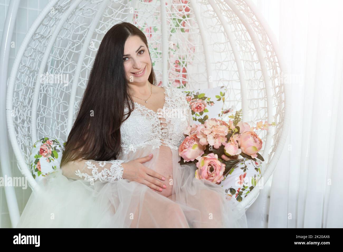 Portrait of a beautiful pregnant woman in a room  Stock Photo