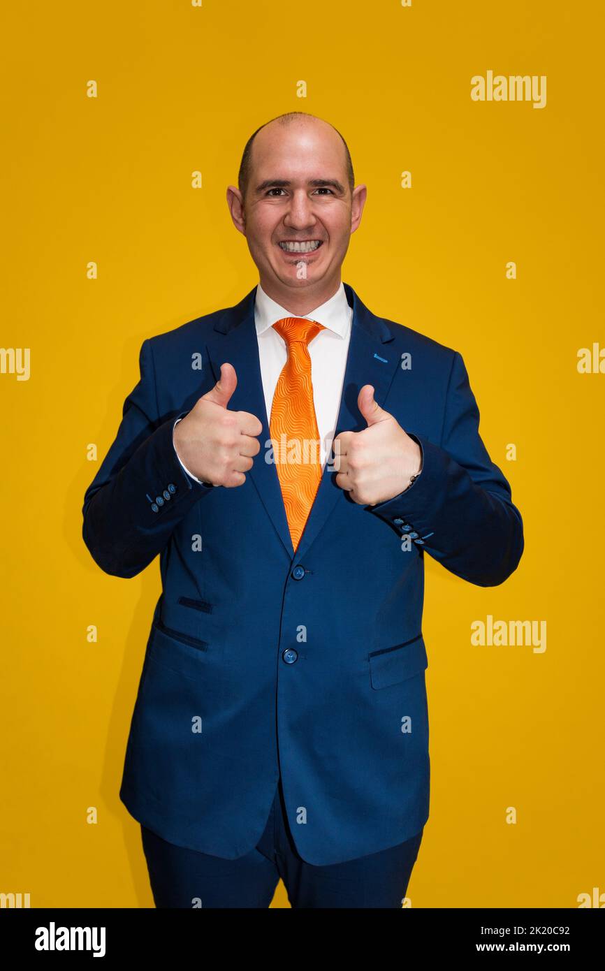 Portrait of a smiling bald Caucasian adult male, dressed in blue suit ...