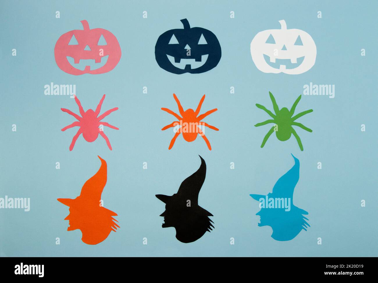 pattern with colorful witch head, spiders and pumpkins, creative halloween concept, flat lay, paper craft Stock Photo