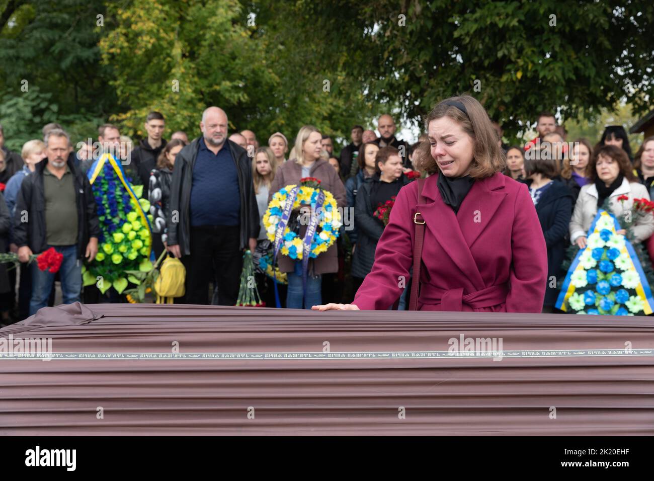 The daughter of the deceased hero weeps next to the coffin with the ...