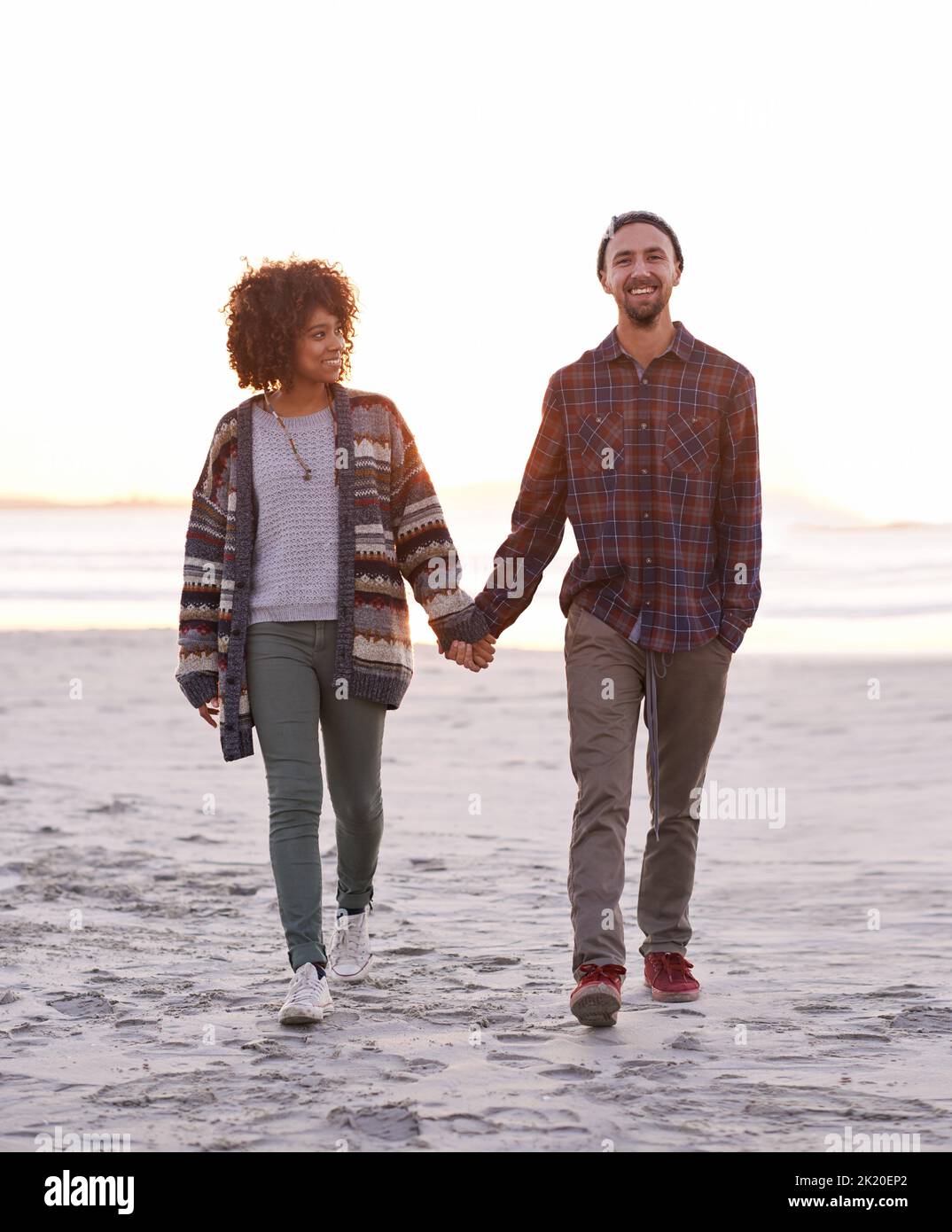She loves the outdoors. a young couple enjoying a walk on the beach Stock Photo Alamy