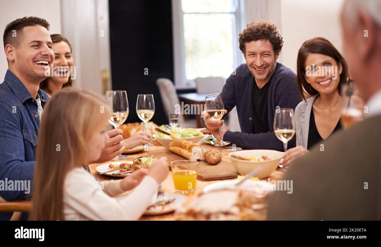 Friends and family are the true gifts in life. a family sitting down to dinner. Stock Photo