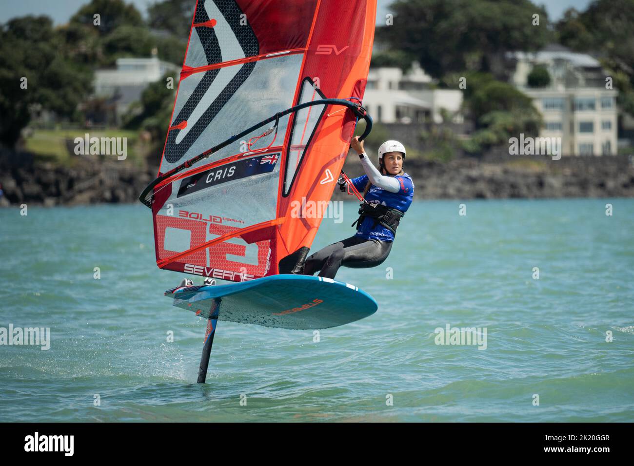 A woman competes in a national windsurfing hydrofoil race at the