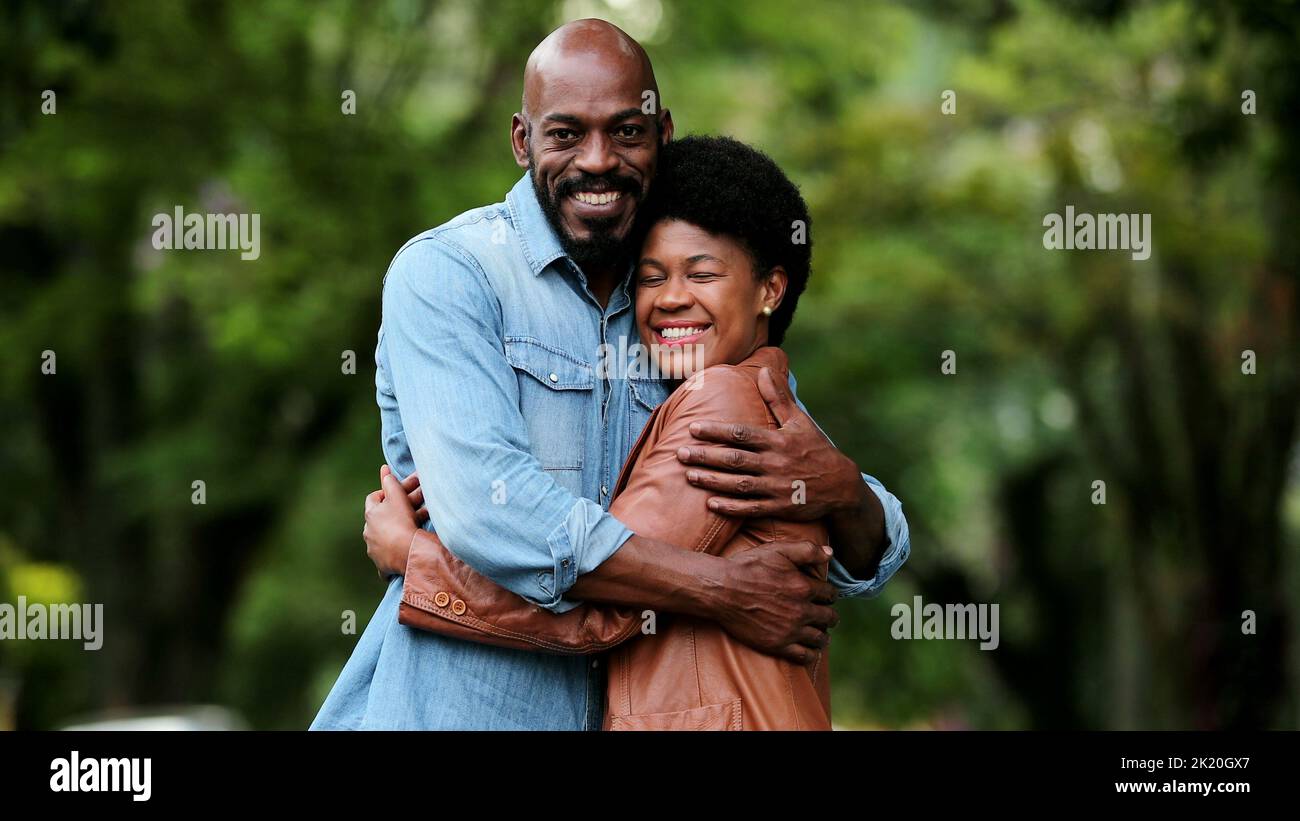 African couple posing outside smiling Stock Photo - Alamy