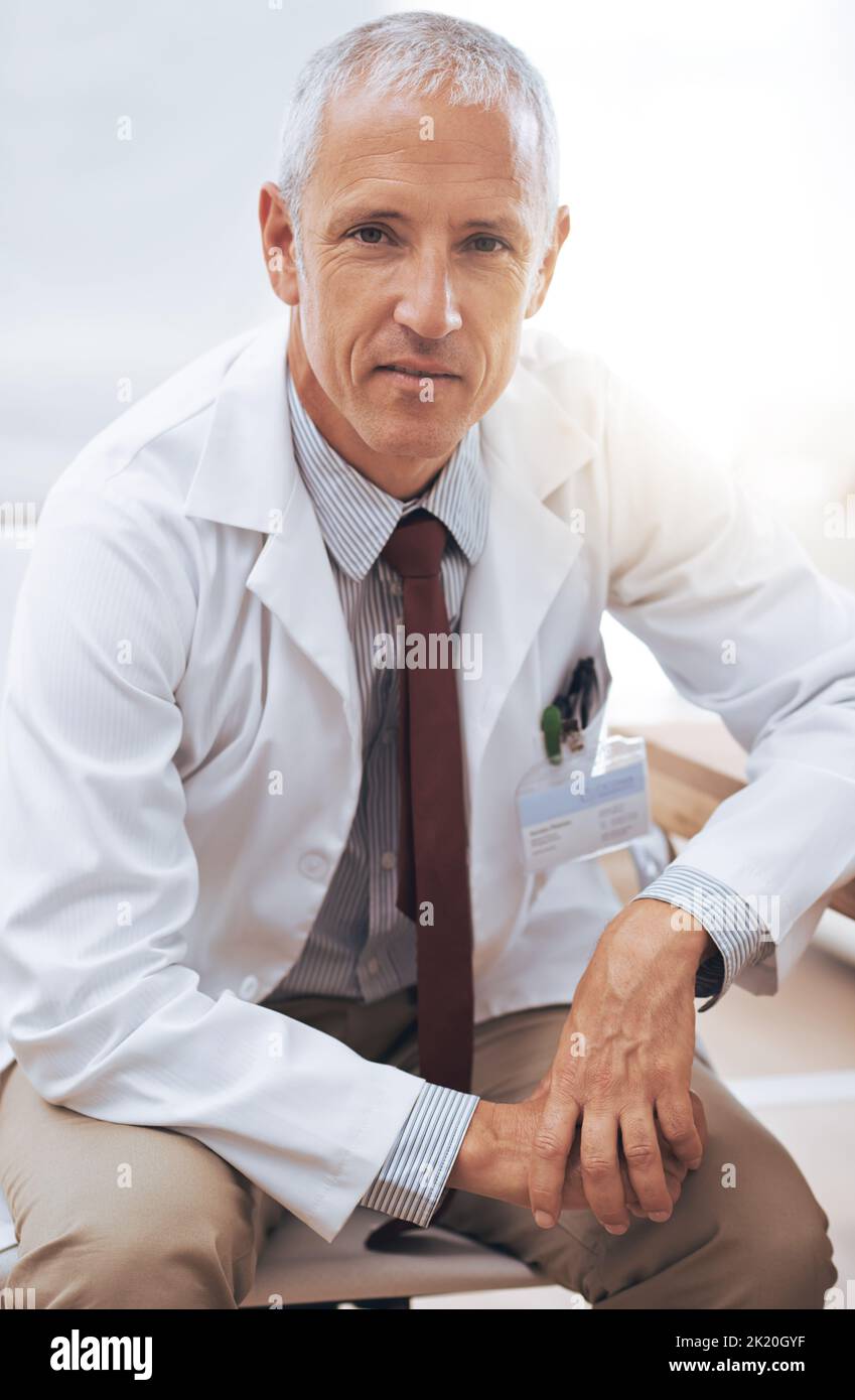 Hes a focused medical professional. Portrait of a serious-looking male doctor sitting in his office. Stock Photo