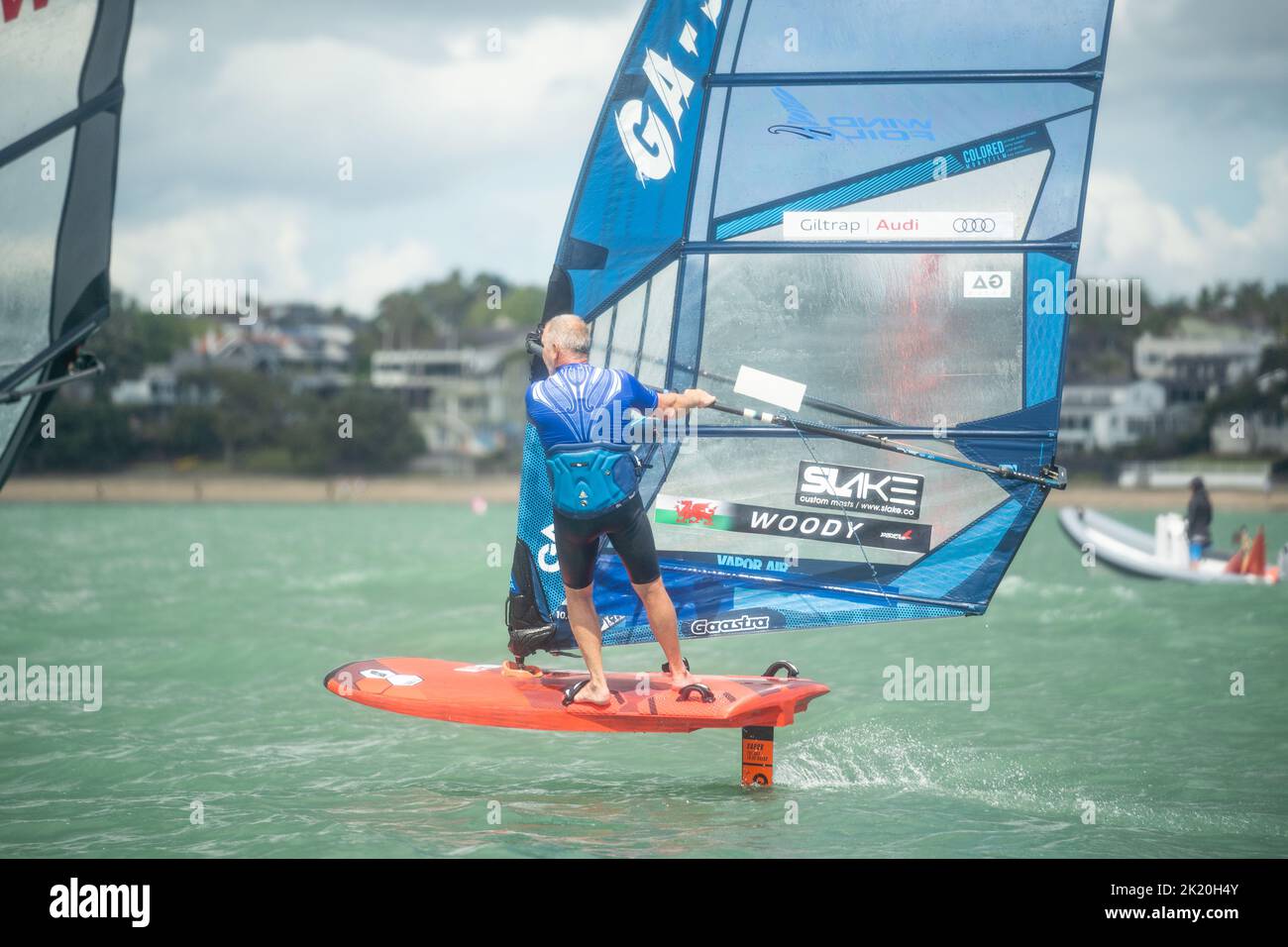 A retired senior man competes in a New Zealand national windsurfing