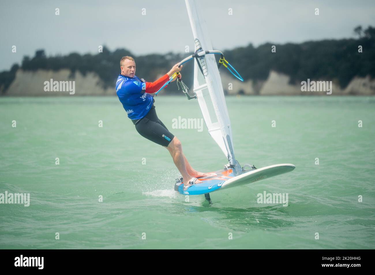 A man competes in a national windsurfing hydrofoil race at the