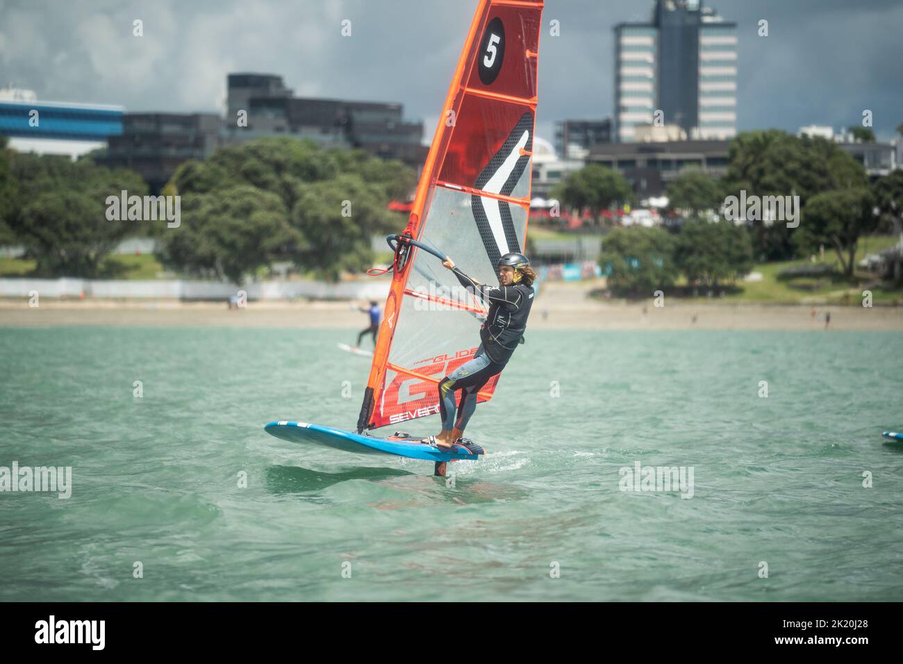 A man competes in a national windsurfing hydrofoil race at the