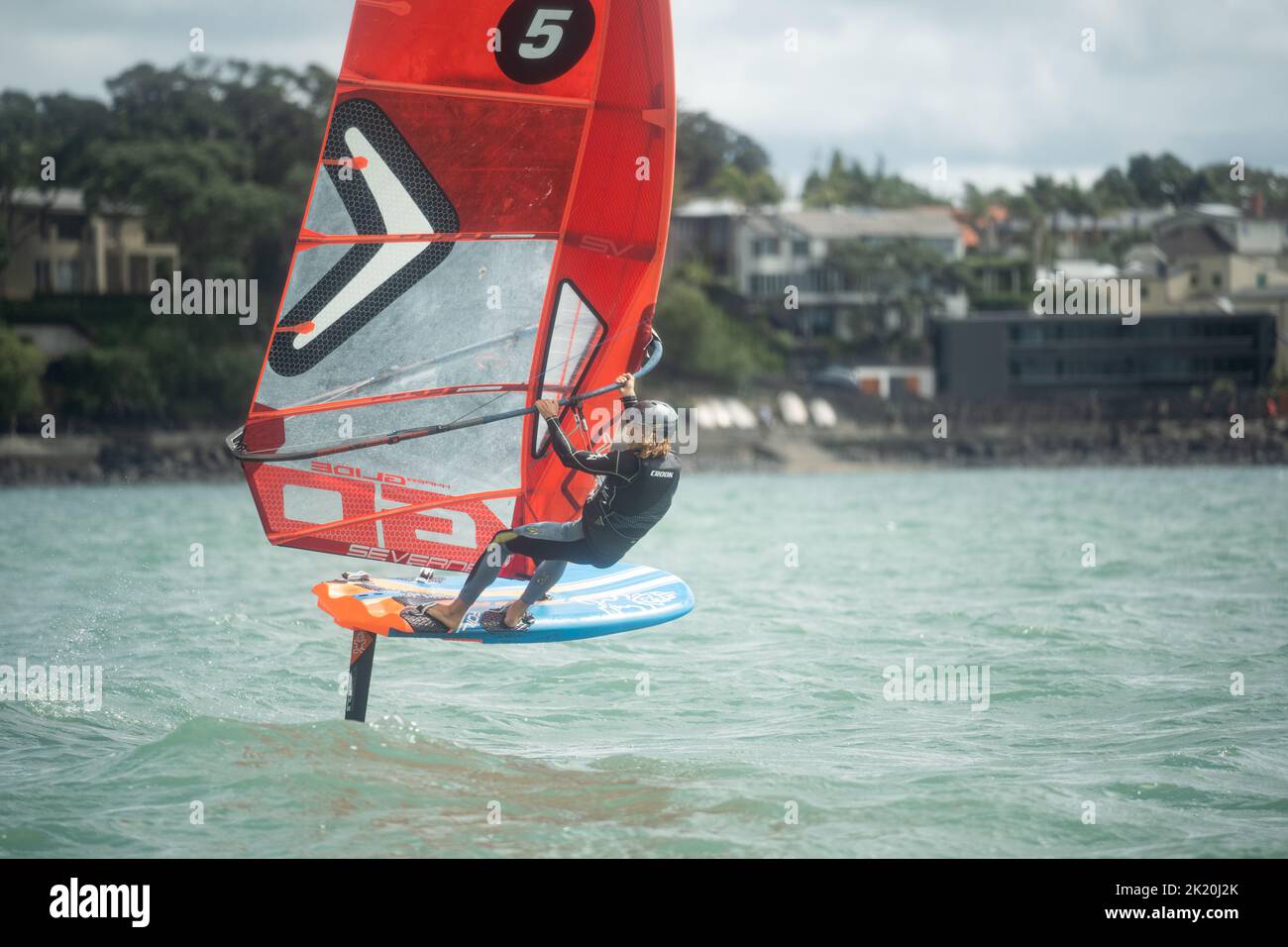 A man competes in a national windsurfing hydrofoil race at the