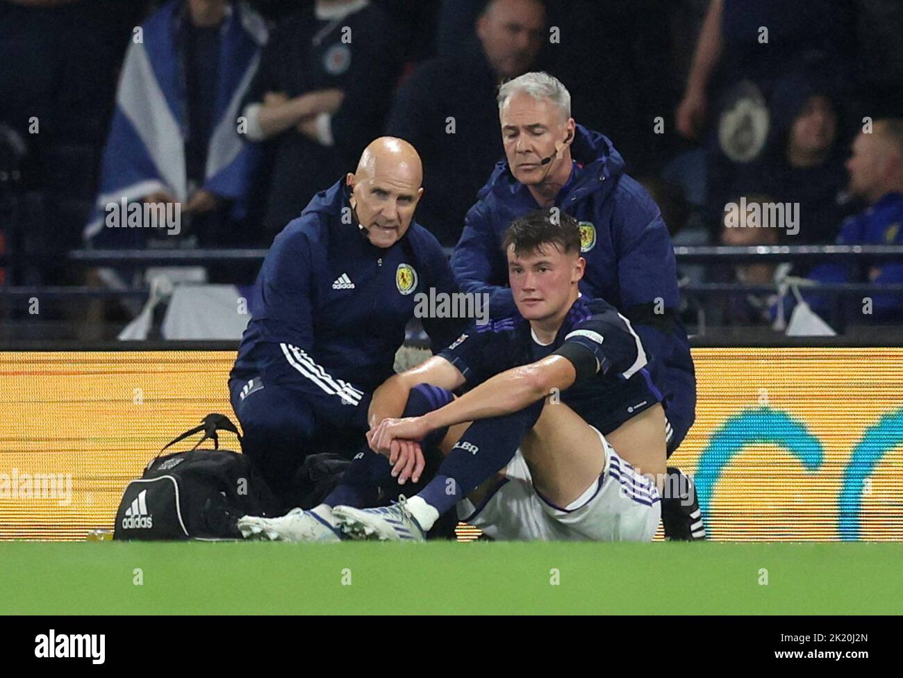Soccer Football - UEFA Nations League - Group E - Scotland v Ukraine - Hampden Park, Glasgow, Scotland, Britain - September 21, 2022 Scotland's Nathan Patterson receives medical attention after sustaining an injury REUTERS/Russell Cheyne Stock Photo