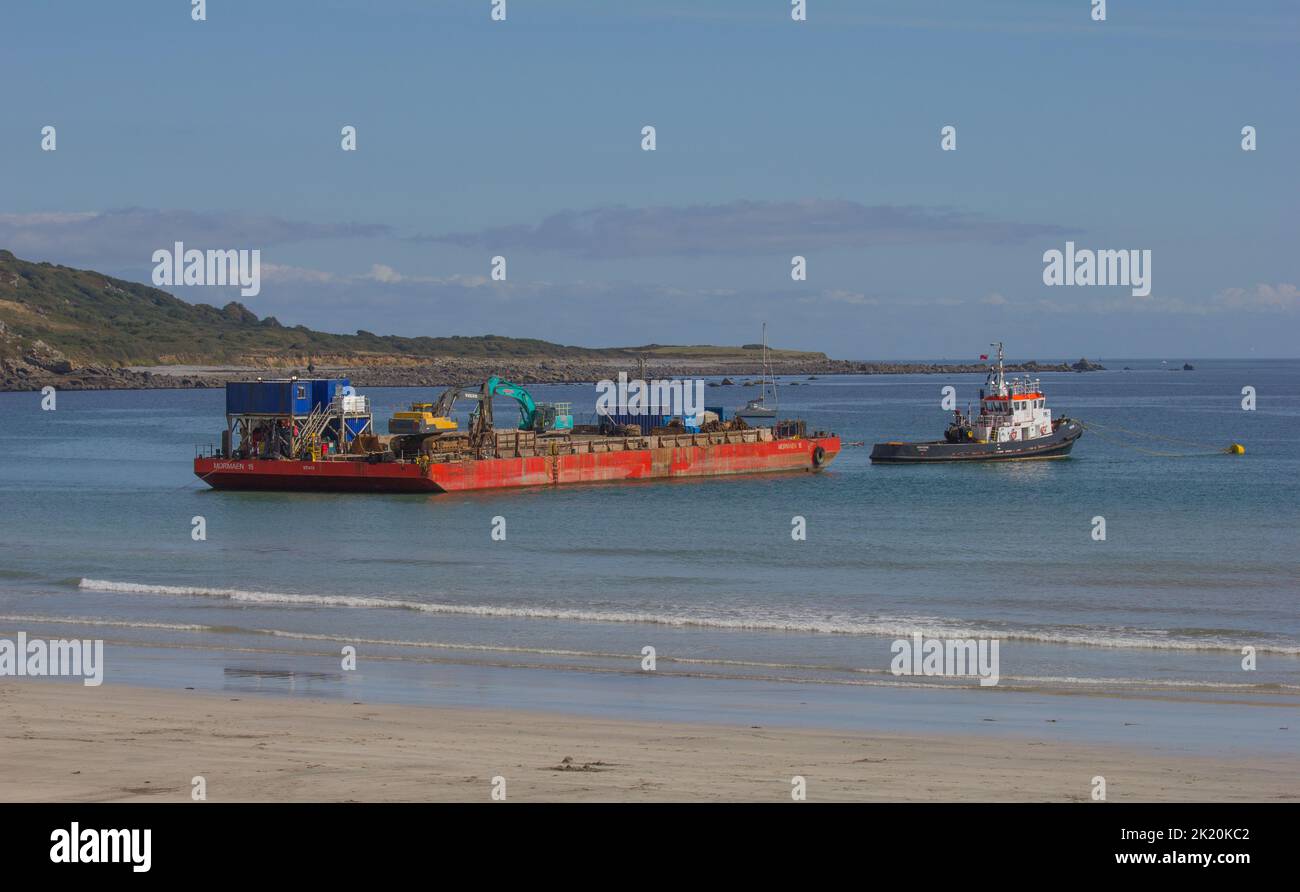 Transport barge and tug after offloading armour rocks for breakwater ...