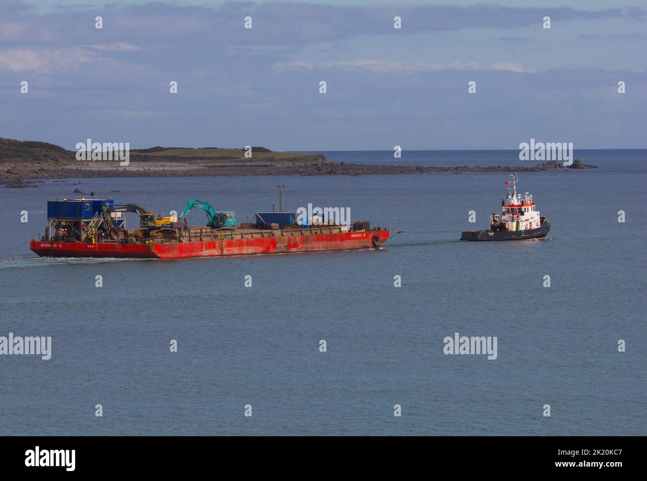 Transport barge and tug after offloading rocks for breakwater ...