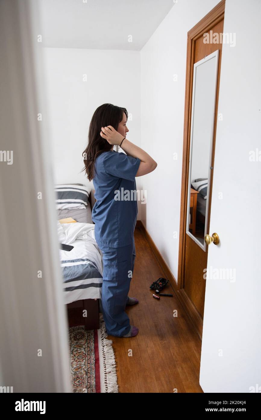 Nurse looking in mirror and getting ready Stock Photo Alamy