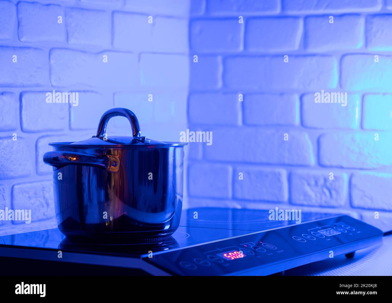 Metal Pot on induction hob in modern kitchen Stock Photo Alamy