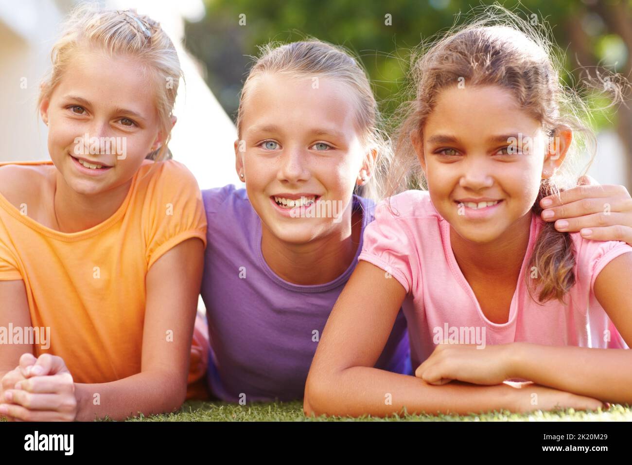 Best friends for life. Portrait of three girls lying on the grass on a