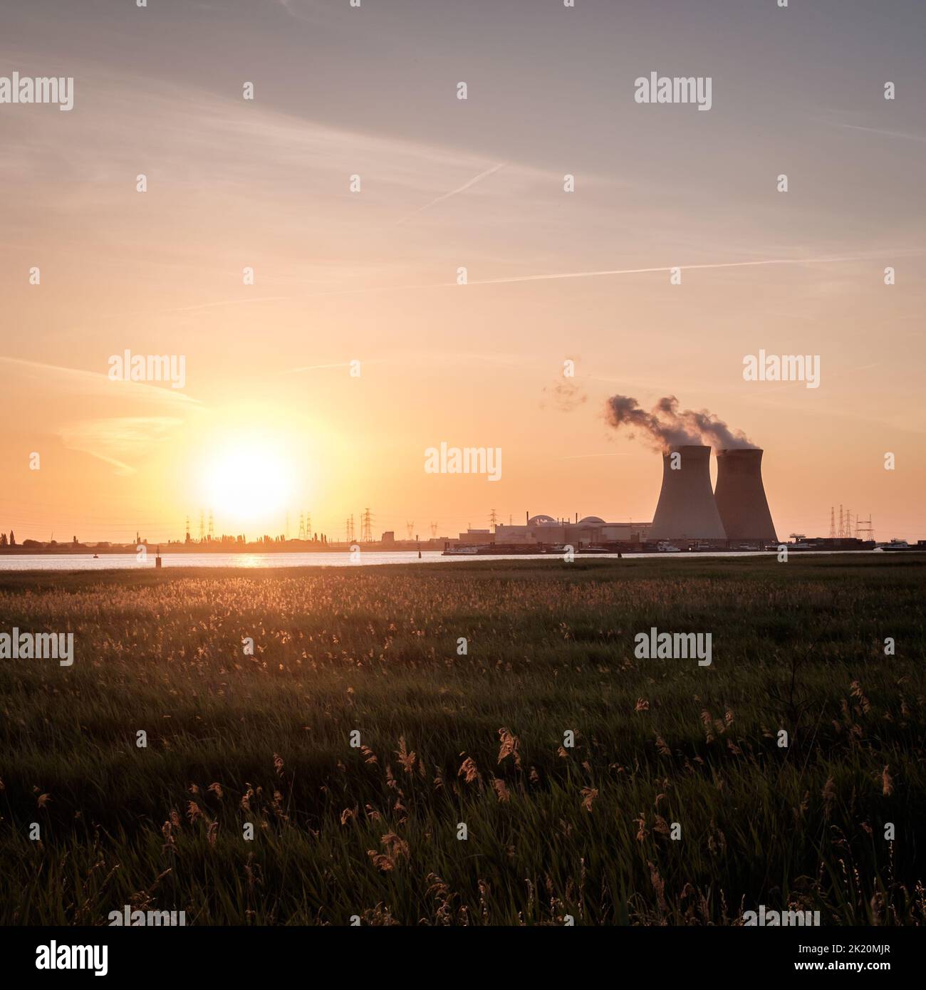 Sunset over the nuclear reactor of Doel in the Port of Antwerp, Belgium. Stock Photo