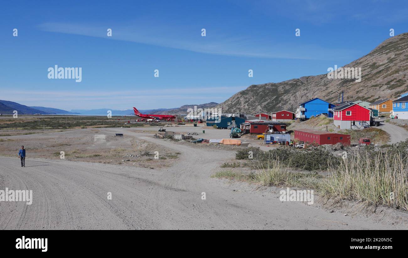 A man walking on a dirt road outside Kangerlussuaq Airport in Greenland Stock Photo