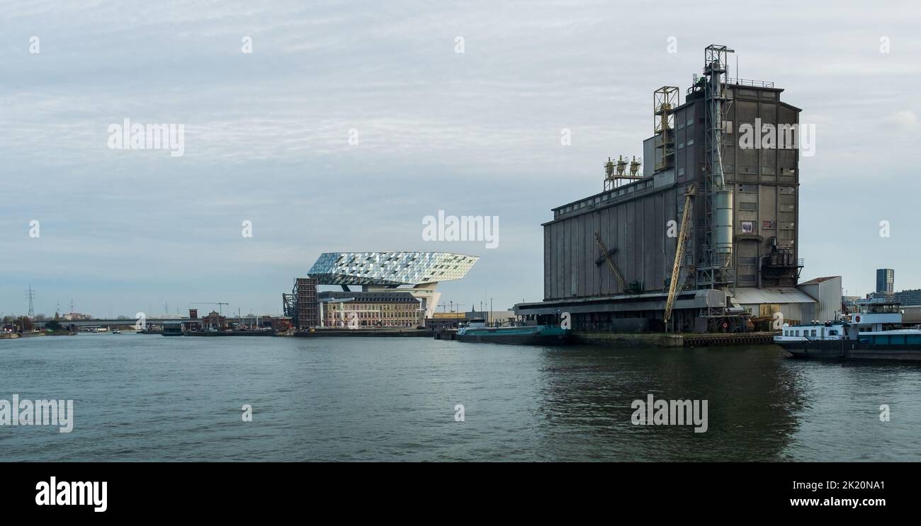 Antwerp, Belgium – 17 November 2019: The new modern Port House next to the old grain warehouses in the Port of Antwerp. The old warehouse will be demo Stock Photo