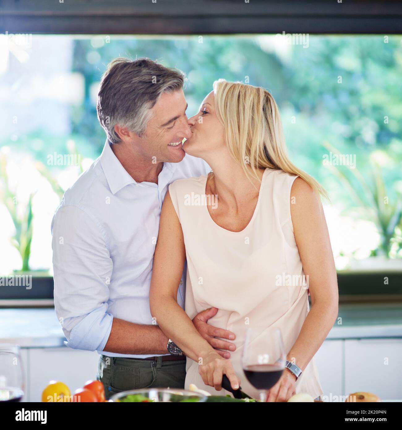 Kitchen romance. an affectionate couple cooking dinner. Stock Photo