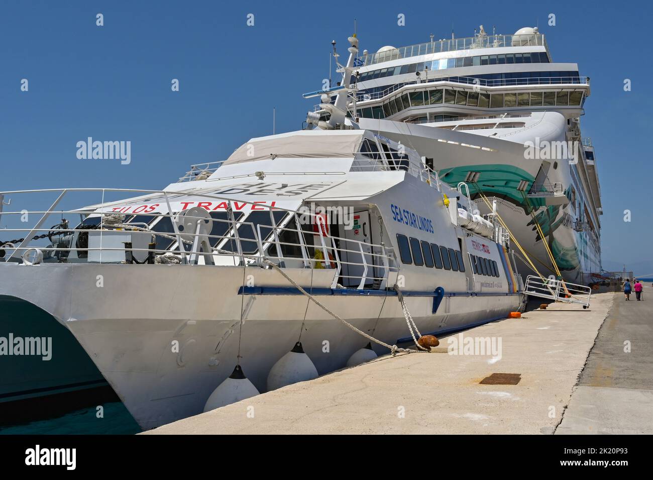 Rhodes, Greece - May 2022: Passenger ferry docked in front of the Norwegian Cruise Line cruise ship Norwegian Jade in the port of Rhodes Stock Photo