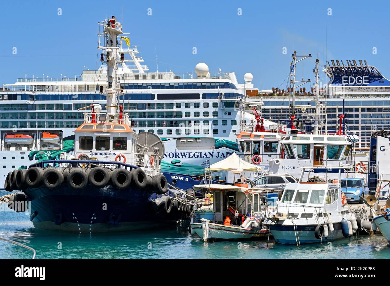 Rhodes, Greece - May 2022: Tugboat and small fishing boats moored in the harbour in Rhodes Stock Photo