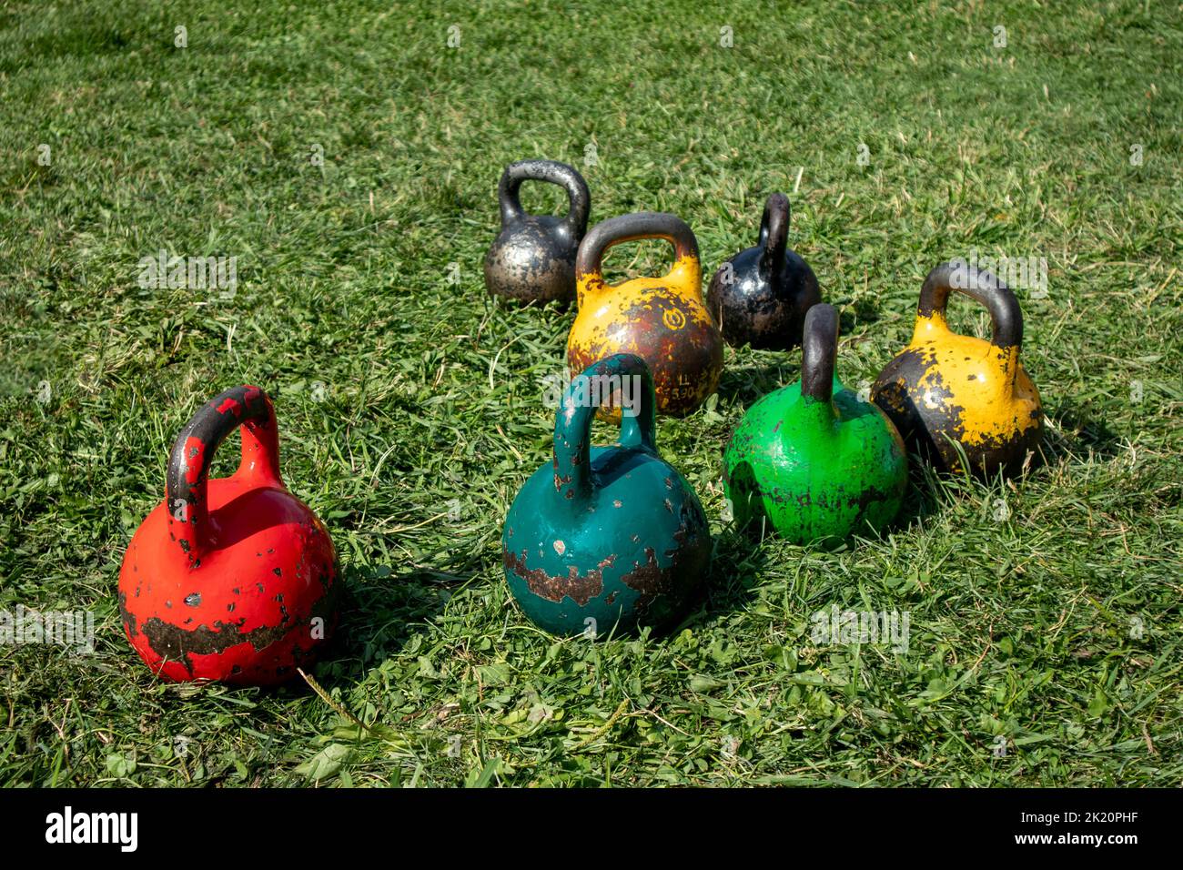 colored round heavy weights on the grass. sport. weightlifting Stock