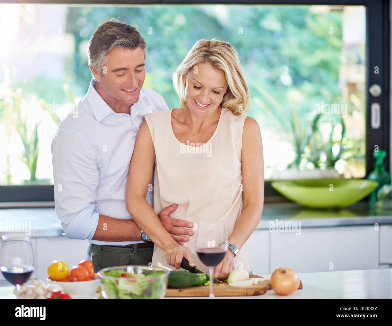 They do everything as a team. an affectionate couple cooking dinner. Stock Photo