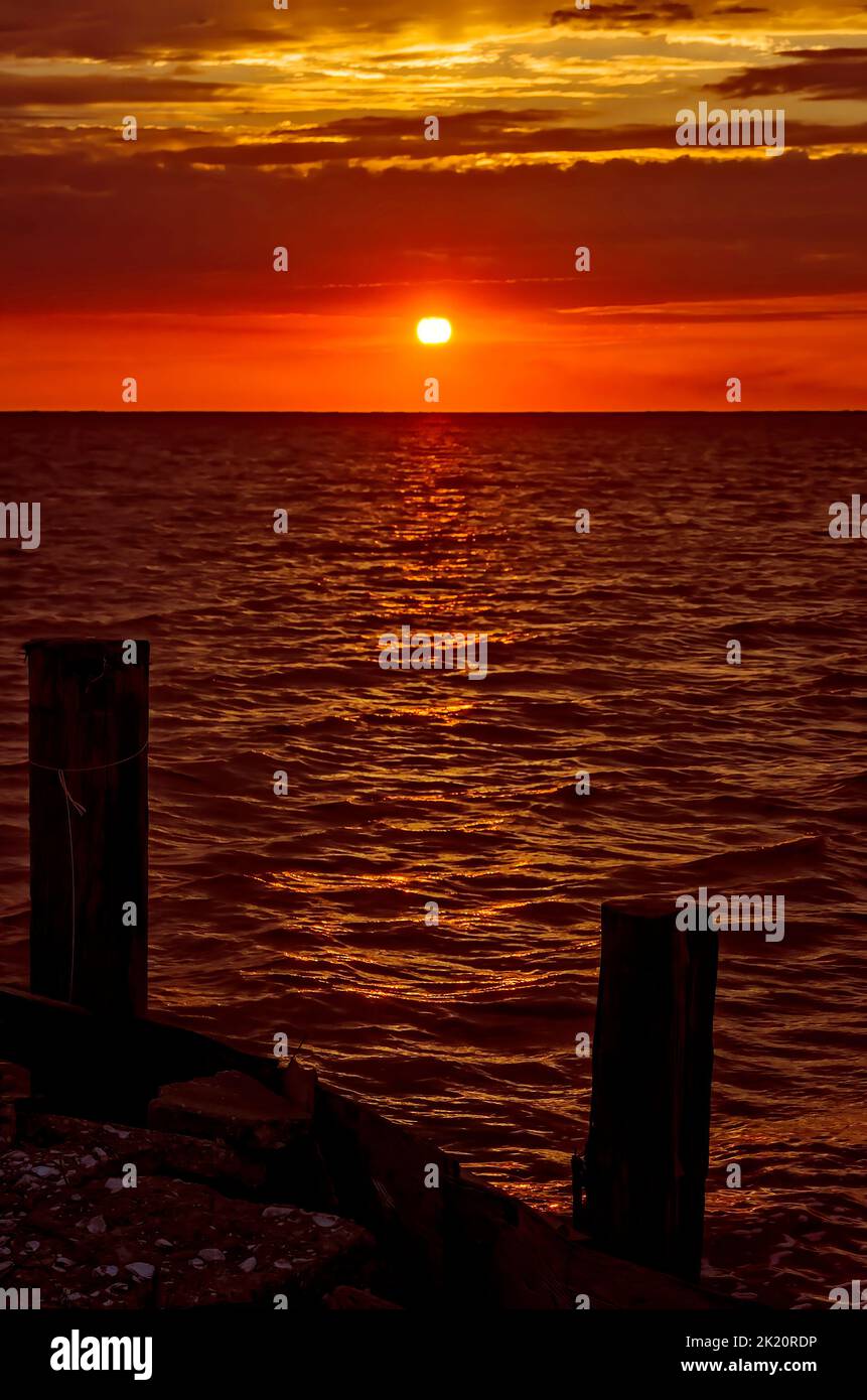 The sun sets at Cedar Point Fishing Pier, May 2, 2014, in Coden, Alabama. Stock Photo