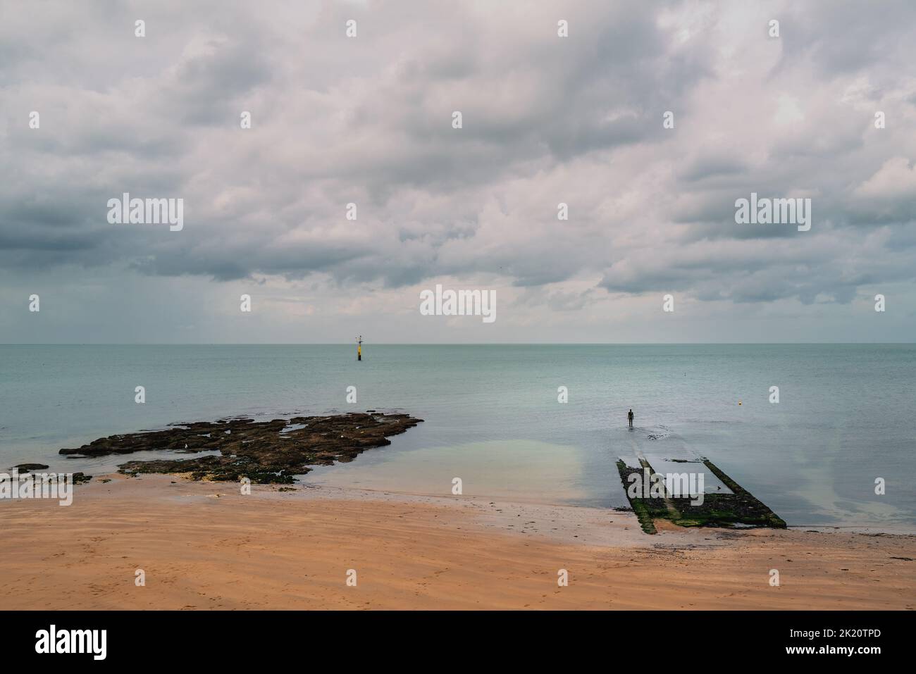 Margate, UK - Sep 7 2022 A sculpture by Antony Gormley of a man looking ...