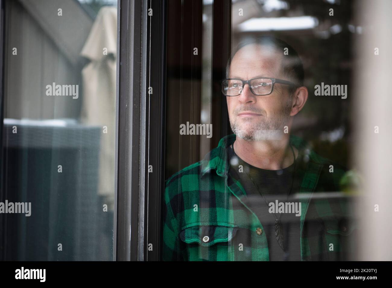Adult look out window of home hi-res stock photography and images - Alamy