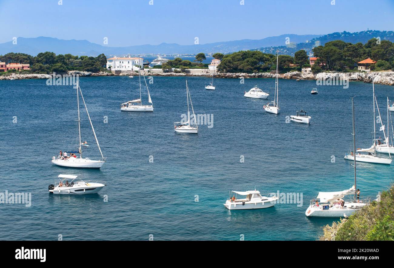 Sailboats, motor boats, and people in billionaire's bay in Cap d'Antibes on the French riviera Stock Photo