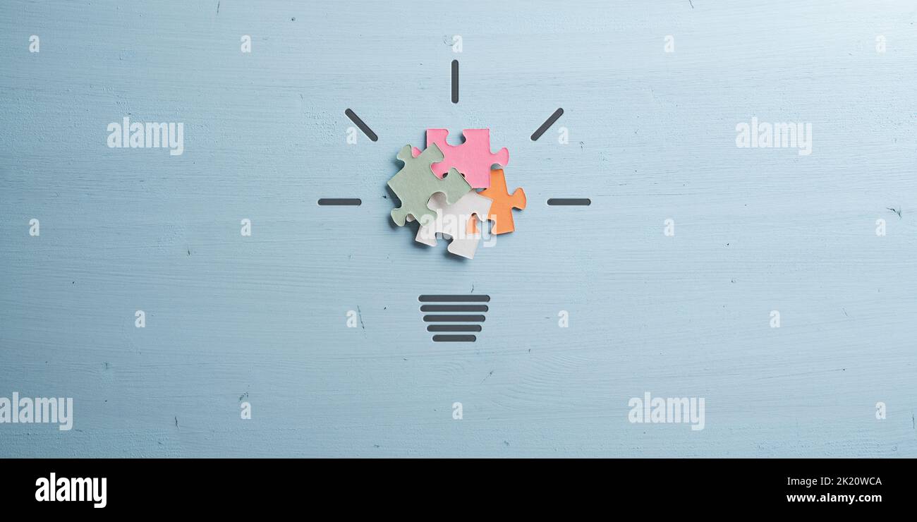 Light bulb made of colorful puzzle pieces in a conceptual image of idea ...