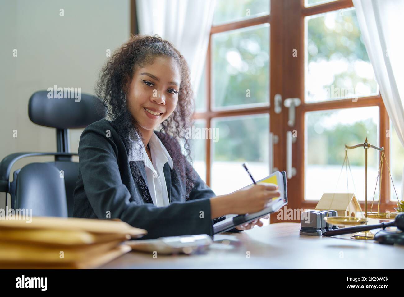 Portrait of an African Americans female lawyer using a notebook to keep track of her work schedule. Stock Photo