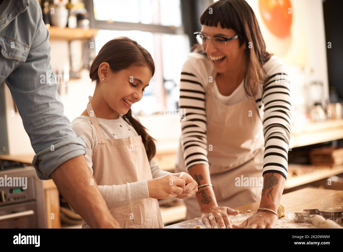 Shes a keen little baker. a family having fun baking in the kitchen. Stock Photo