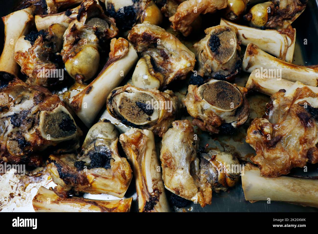 roasted veal marrow bone or beef bone from the oven for stock or sauce preparation Stock Photo