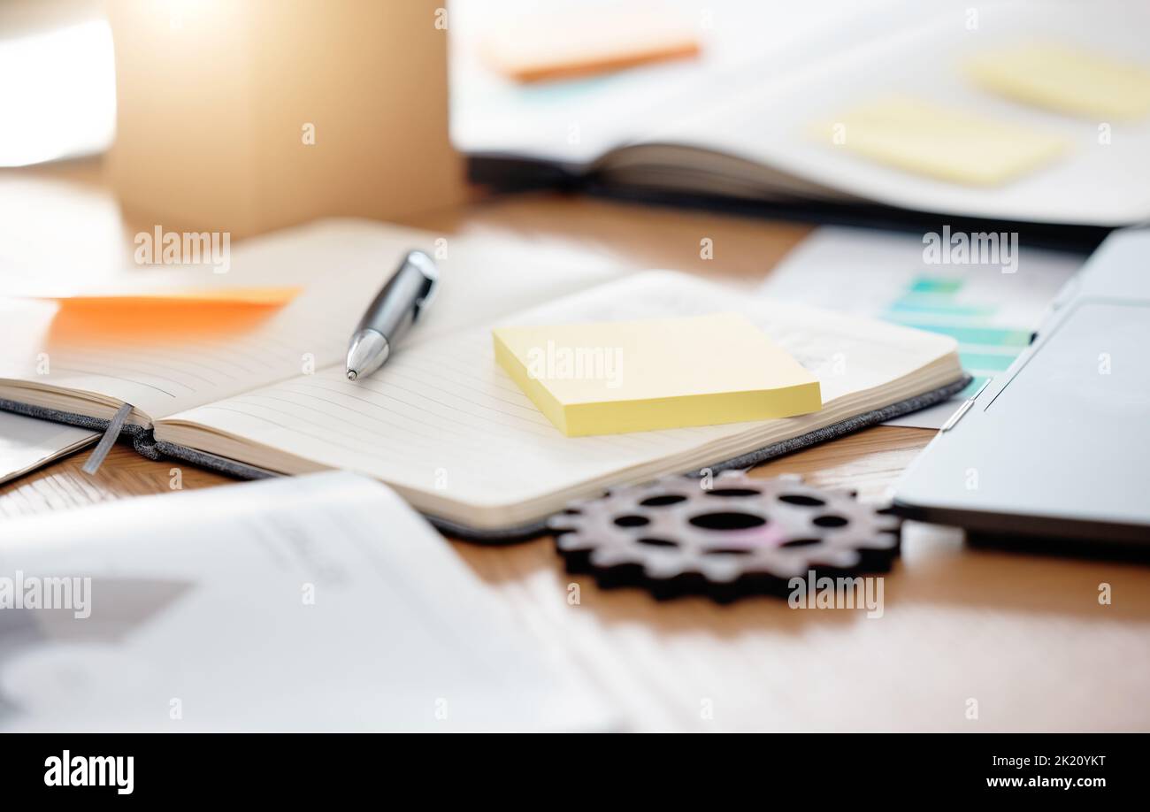 Table, paperwork and sticky note planning, strategy and brainstorming notebook at an office. Business work desk of gadgets for scheduling, ideas and Stock Photo