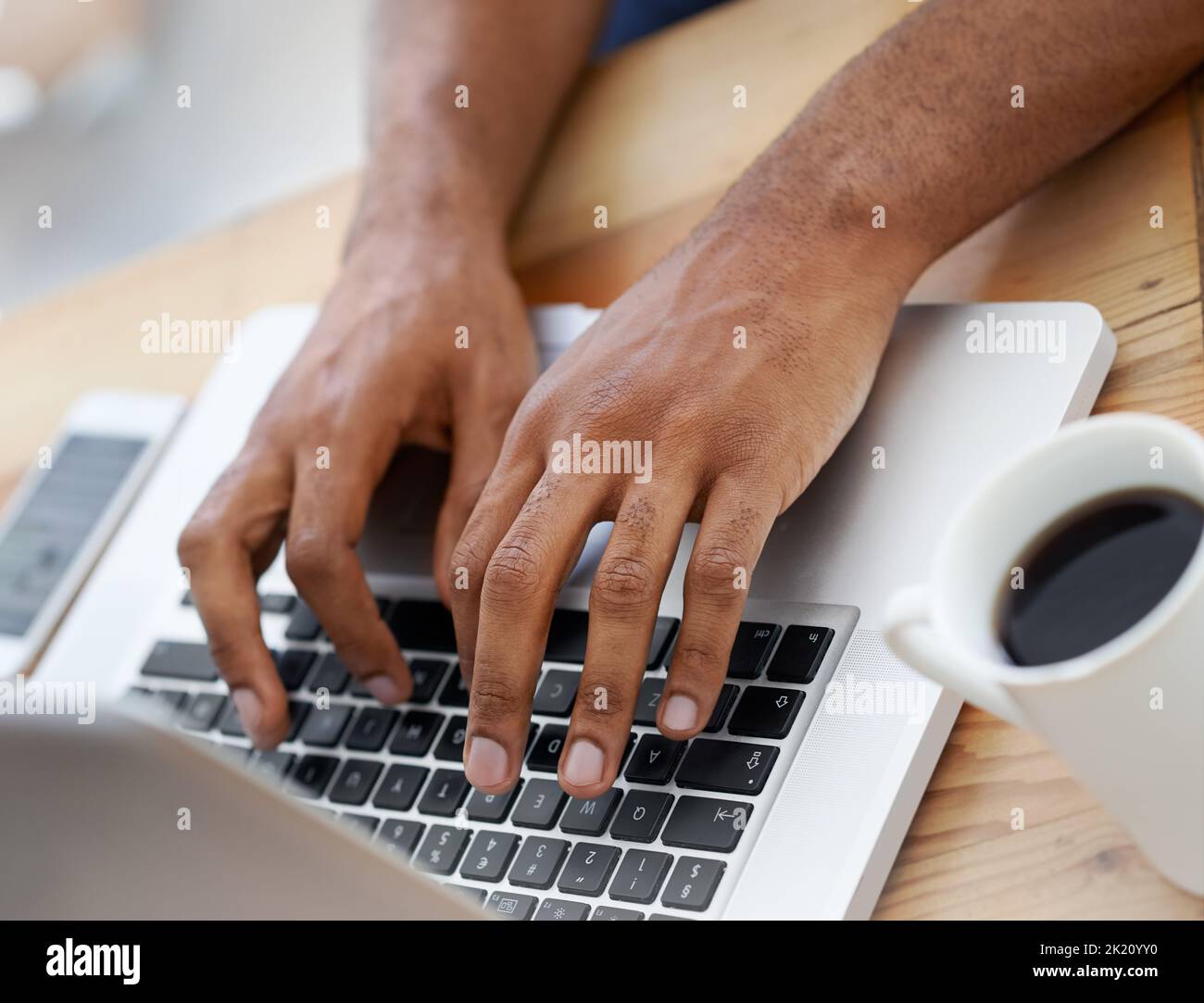 Hard at work. Cropped view of a businessmans hands as he types on his laptop. Stock Photo