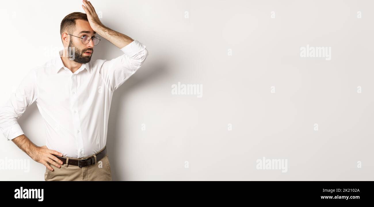 Annoyed man manager roll his eyes and slap forehead, facepalm from