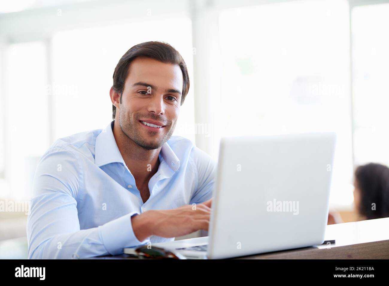 Another great day at the office. Portrait of a handsome businessman using his laptop in the office. Stock Photo