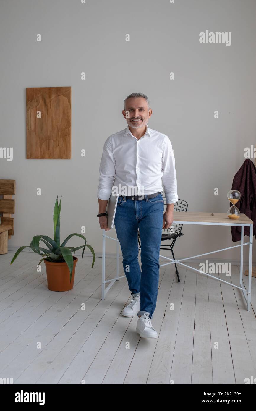 A mature man in a white shirt in the office Stock Photo