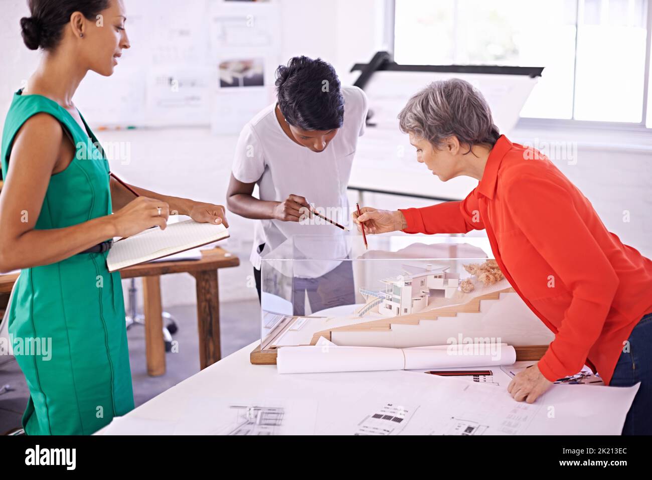 Going over the finer details. a group of female architects working together on a project. Stock Photo