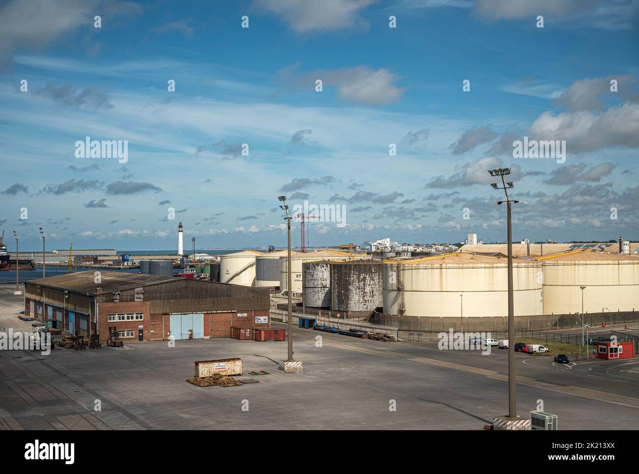 Europe, France, Dunkerque - July 9, 2022: Port scenery. BARRA SNM Terminal and office building in front of its large cylindrical petroleum tanks under Stock Photo