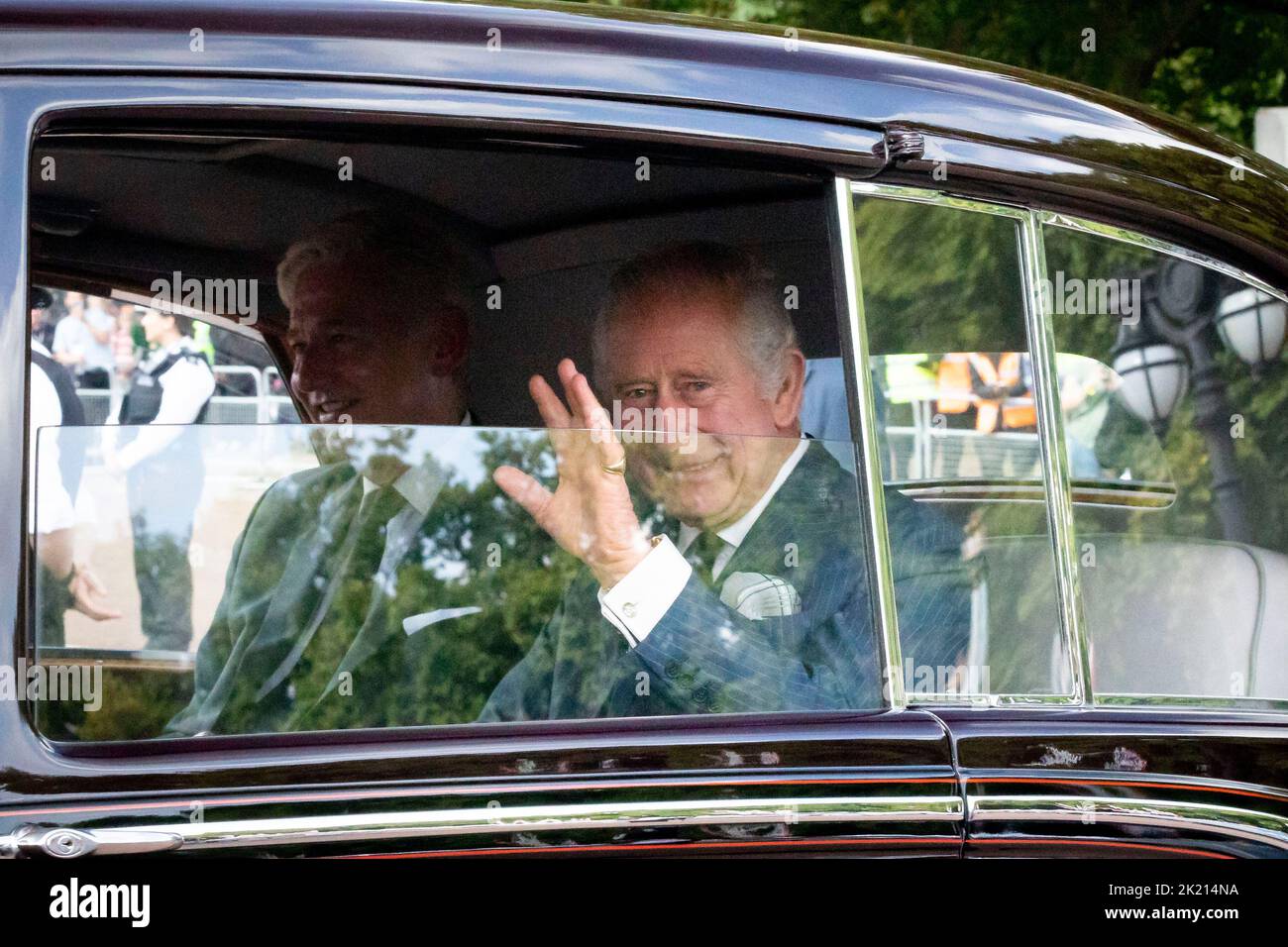 King Charles III returns to Buckingham Palace in a car surrounded by royal fans and well-wishers as the nation continues to mourn for the loss of Quee Stock Photo