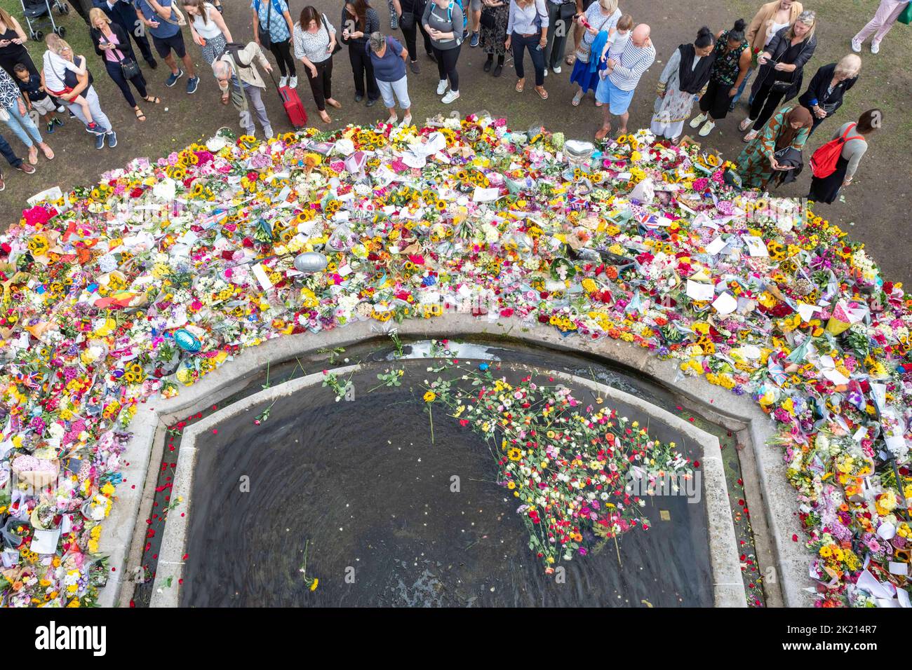 People continue to bring forward flowers to pay tribute to Queen Elizabeth II. The nation continues to mourn for her death last Thursday.   Image shot Stock Photo