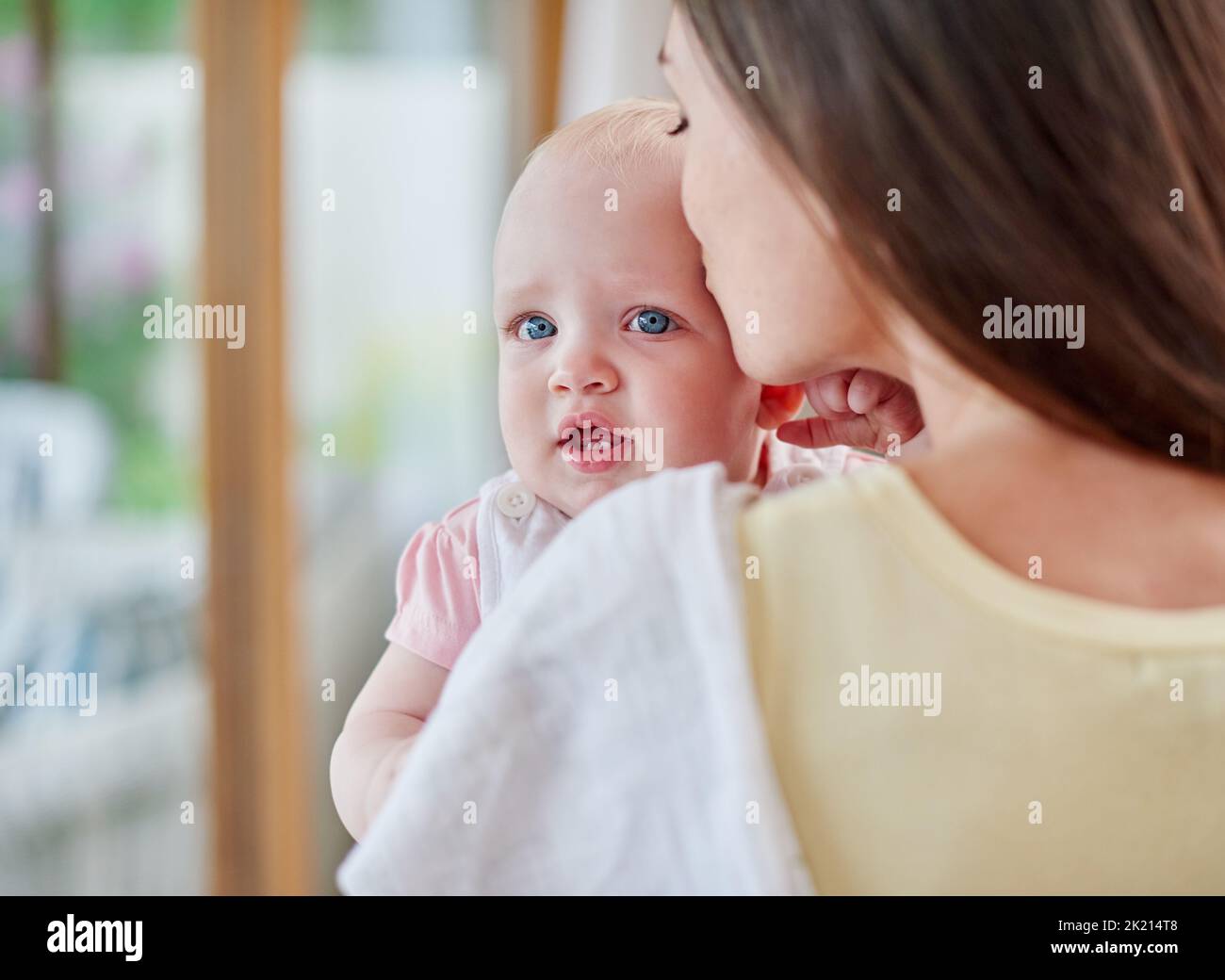 Kisses for my baby. Over the shoulder shot of a mother kissing her baby