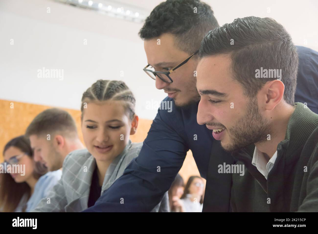 Professor having discussion with his college students Stock Photo