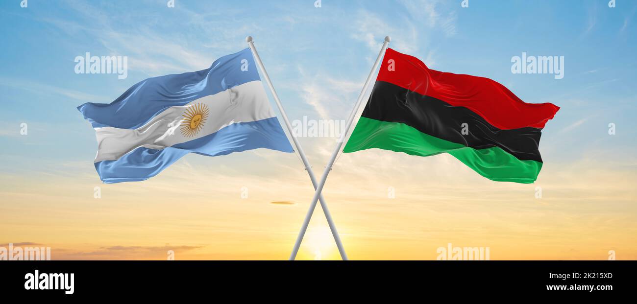 crossed national flags of Argentine and Pan-African flag waving in wind ...